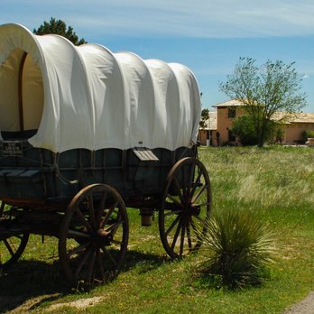 Scotts Bluff National Monument - Replica of a typical pioneer wagon with the visitors center behind. - Landmarks & Historical Buildings Near Me - Gering, Nebraska Scotts Bluff National Monument - Replica of a typical pioneer wagon with the visitors center behind. - Landmarks & Historical Buildings Near Me - Gering, Nebraska