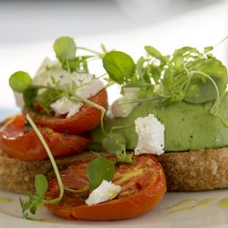 Three Girls Skipping - Avocado on sourdough toast with roasted, farm-fresh Roma tomatoes, Persian feta, rocket and cress salad and is topped with a light olive oil
