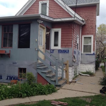 Second City Roofing & Exteriors - The back porch, soon after siding work began. You can see the old cedar shingle siding with chipping paint. - Roofing Near Me - Chicago, Illinois