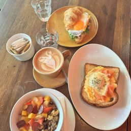 Granola and yogurt , smoked salmon with rags on toast& breakfast croissant with egg.
