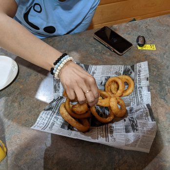 Rocky Ledge Resort - a person grabbing a doughnut from a basket - American Near Me - Kabetogama, Minnesota Rocky Ledge Resort - a person grabbing a doughnut from a basket - American Near Me - Kabetogama, Minnesota