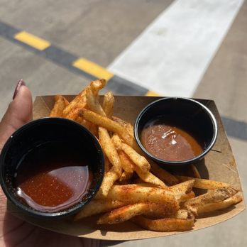 Mr. Kamal's - a hand holding a tray of fries and dipping sauce - Indian Near Me - Orlando, Florida Mr. Kamal's - a hand holding a tray of fries and dipping sauce - Indian Near Me - Orlando, Florida