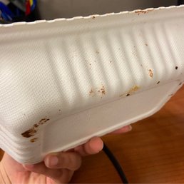Dirty box with food inside