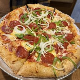 Pizza with pepperoni, bell peppers, and onions Pizza with pepperoni, bell peppers, and onions