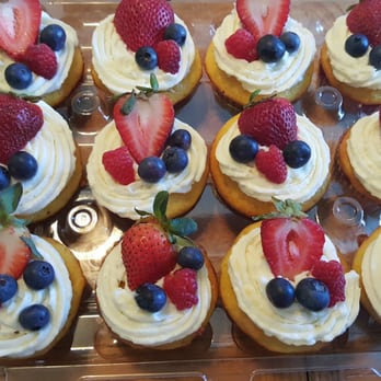 Legendary Chantilly Cakes - a tray of cupcakes with strawberries and blueberries - Bakeries Near Me - Marrero, Louisiana