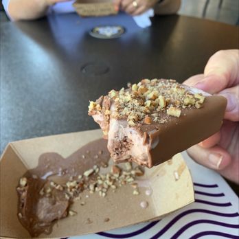 Picolé Pops - Ferraro Rochor pop dipppd in milk chocolate and pecan sprinkled on top - Ice Cream & Frozen Yogurt Near Me - Dallas, Texas