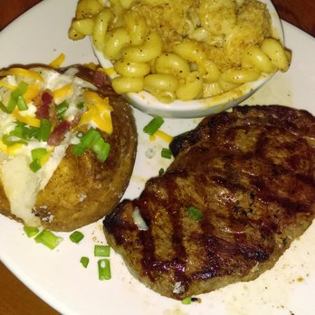 Outback Steakhouse - 12oz Ribeye with baked potato and smokehouse mac n cheese - Steakhouses Near Me - Delray Beach, Florida Outback Steakhouse - 12oz Ribeye with baked potato and smokehouse mac n cheese - Steakhouses Near Me - Delray Beach, Florida