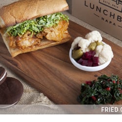 Fried Chicken Sandwich with Maple Chili Glaze, House-made Pickles, Greens and Sandwich Cookie