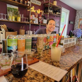 Nostrano Vineyards - Kay, one of Nostrano's owners, the empty glasses from a flight, a glass of baco noir, and pina colada slushy - Wineries Near Me - Milton, New York Nostrano Vineyards - Kay, one of Nostrano's owners, the empty glasses from a flight, a glass of baco noir, and pina colada slushy - Wineries Near Me - Milton, New York