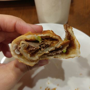 Peaceful Restaurant - A half eaten beef roll. It was so good that I almost forgot to take a picture. It's actually quite large and it's worth the $7! - Chinese Near Me - Vancouver, British Columbia Peaceful Restaurant - A half eaten beef roll. It was so good that I almost forgot to take a picture. It's actually quite large and it's worth the $7! - Chinese Near Me - Vancouver, British Columbia