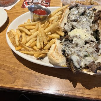 Twin Peaks - Philly Cheesesteak with French Fries - Sports Bars Near Me - Fort Myers, Florida Twin Peaks - Philly Cheesesteak with French Fries - Sports Bars Near Me - Fort Myers, Florida