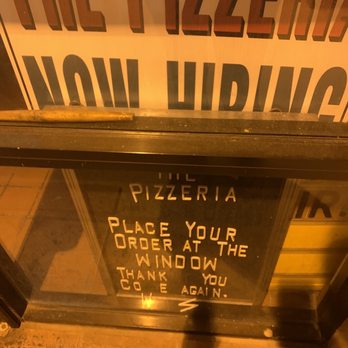 The Pizzeria - a sign in a window - Pizza Near Me - Huntsville, Alabama The Pizzeria - a sign in a window - Pizza Near Me - Huntsville, Alabama