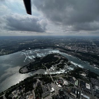 Rainbow Air - American side of the falls at the bottom of photo, Toronto across the river/falls. - Aerial Tours Near Me - Niagara Falls, New York Rainbow Air - American side of the falls at the bottom of photo, Toronto across the river/falls. - Aerial Tours Near Me - Niagara Falls, New York