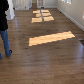 Phil's Floor Service - a man standing in an empty room - Flooring Near Me