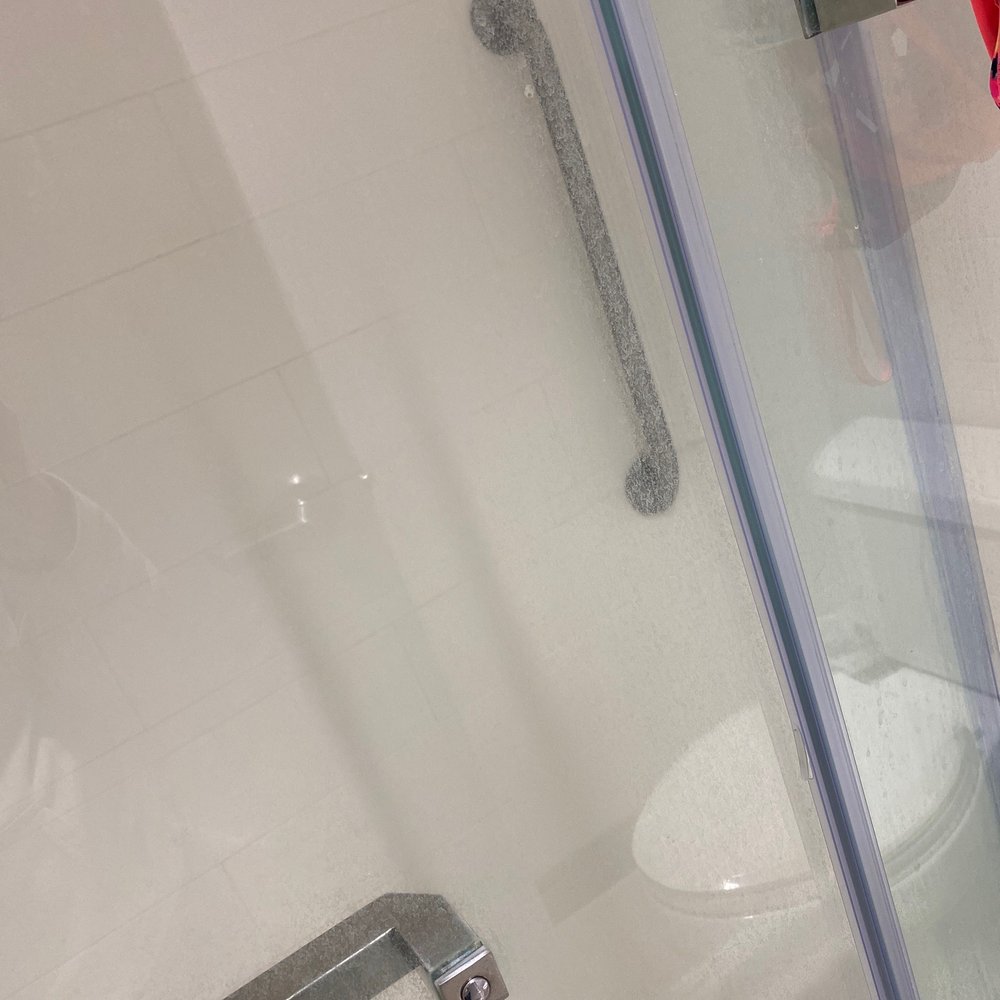 Shower door looks like it hasn't been cleaned in a while. Shower door looks like it hasn't been cleaned in a while.