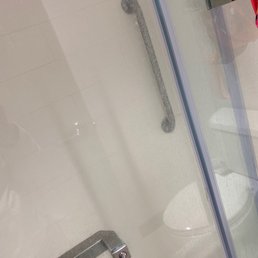 Shower door looks like it hasn't been cleaned in a while. Shower door looks like it hasn't been cleaned in a while.