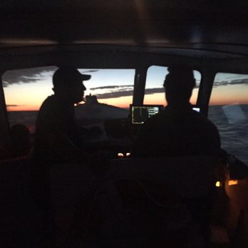 Fishing Frenzy Charters - Captain Scott and first mate Mike during sunrise - Fishing Near Me - Boston, Massachusetts
