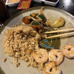 Shrimp fried rice and veggies with the garlic butter sauce in the red cup. Shrimp fried rice and veggies with the garlic butter sauce in the red cup.