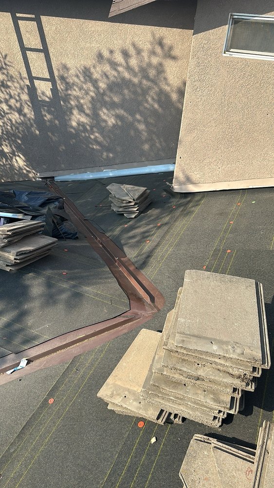 Slide of T’s Roofing 