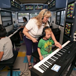 The Music Bus - Patti Graetz, owner of The Music Bus, instructs a beginning piano student.