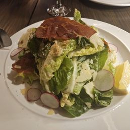 Gem Caesar Salad ($20). Baby gem lettuce, radicchio, crisped prosciutto, radish, breadcrumbs, parmesan, and house Caesar dressing. Gem Caesar Salad ($20). Baby gem lettuce, radicchio, crisped prosciutto, radish, breadcrumbs, parmesan, and house Caesar dressing.