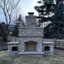 Aurelio Construction - Outdoor fireplace with the wood, cut outs and room to put pizza oven on sides Stone mason. Aurelio construction company.