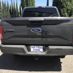 Express Auto Body & Paint - Truck with scratch by blue Ford logo.
