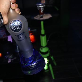 Luxe Hookah Lounge - a hand holding a bottle of vodka - Hookah Bars Near Me - Chicago, Illinois Luxe Hookah Lounge - a hand holding a bottle of vodka - Hookah Bars Near Me - Chicago, Illinois