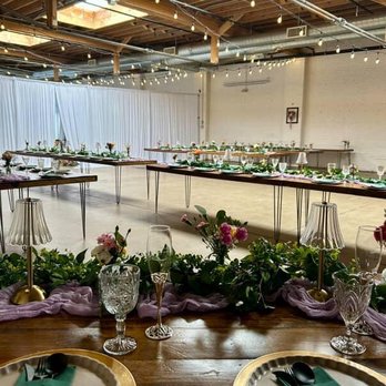 SKYLIGHT - An indoor event venue features long tables with floral centerpieces, string lights hanging from the ceiling, and skylights providing natural light. - Venues & Event Spaces Near Me - Denver, Colorado