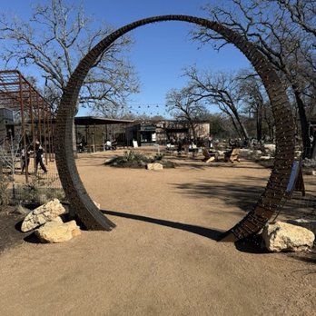 Leona Botanical Cafe & Bar - Entry to park (arch) - Cocktail Bars Near Me - Sunset Valley, Texas Leona Botanical Cafe & Bar - Entry to park (arch) - Cocktail Bars Near Me - Sunset Valley, Texas