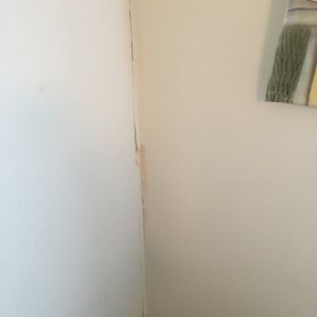 Bluewater Real Estate - Damaged wall in bedroom - Real Estate Services Near Me - Emerald Isle, North Carolina