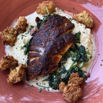Grace & Grit - Blackened grouper over grits spinach and fried oysters. - Southern Near Me - Mount Pleasant, South Carolina