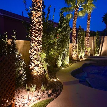 Mauri Landscapes - a pool and palm trees at night - Landscaping Near Me - Las Vegas, Nevada
