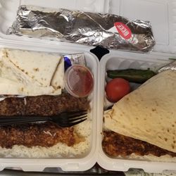 The combo plate; 1 chicken Luleh skewer , 1 beef Luleh skewer, rice, grilled jalapeno, grilled tomato, lavash bread