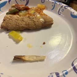 Papa Johns Pizza - The piece of wood found within our pizza. (in front of the piece of pizza)