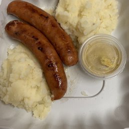 A serving of smoked bratwurst with mashed potatoes on the side. What a wonderful quick meal for lunch or dinner.