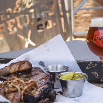 Triple G Group - a glass of beer and a plate of ribs - Food Trucks Near Me - Prosper, Texas