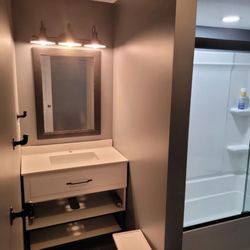 Bathroom vanity light and 6" wafer light in shower.