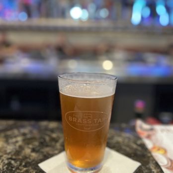 The Brass Tap - a glass of beer on a table - Beer Bar Near Me - Palm Coast, Florida The Brass Tap - a glass of beer on a table - Beer Bar Near Me - Palm Coast, Florida