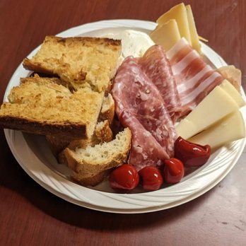 Emiliano's Market - An assortment of imported Salumi E Formaggi along with some olives, peppers, and a baguette turned into garlic bread - all from Emiliano's - Italian Near Me - Bronx, New York Emiliano's Market - An assortment of imported Salumi E Formaggi along with some olives, peppers, and a baguette turned into garlic bread - all from Emiliano's - Italian Near Me - Bronx, New York
