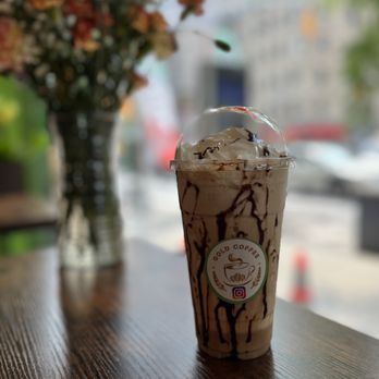 Gold coffee - a cup of iced coffee on a table - Coffee & Tea Near Me - New York, New York