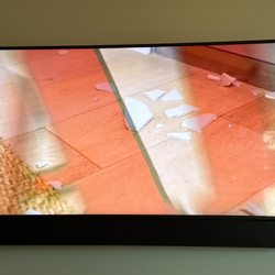 Praxis - Custom width thin speaker below HDTV Frame TV. Not seen, surround ceiling speakers and in wall concealed subwoofer.