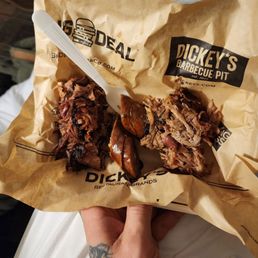 a pulled pork sandwich in a paper bag a pulled pork sandwich in a paper bag