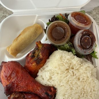 Rice Box & Boba  - The fried chicken with sticky rice entree - A styrofoam takeout container holds fried chicken, sticky rice, a spring roll, a small salad, and three small containers of dipping sauces. - Laotian Near Me - Albuquerque, New Mexico