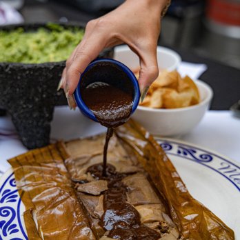Mezcal - (INSIDE) Tamal de Mole: Chicken Tamal w/Mole Negro, wrapped in a banana leaf - Mexican Near Me - San Jose, California Mezcal - (INSIDE) Tamal de Mole: Chicken Tamal w/Mole Negro, wrapped in a banana leaf - Mexican Near Me - San Jose, California