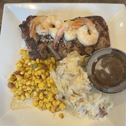 Steak special with mashed potatoes with side of gravy, seasoned corn and shrimp scampi Steak special with mashed potatoes with side of gravy, seasoned corn and shrimp scampi