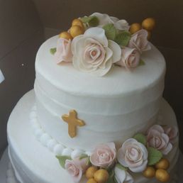 A beautiful two tier cinnamon and carrot cakes with buttercream icing and fondant flowers for a lovely baby girls baptism. A beautiful two tier cinnamon and carrot cakes with buttercream icing and fondant flowers for a lovely baby girls baptism.