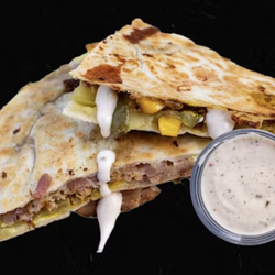 Pita Pit - Melted cheese with smoky bacon, BBQ sauce, and crispy onions on grilled bread--a bold twist on classic comfort.