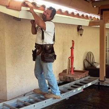 BRG Seamless Rain Gutters - Here is BRG's owner putting up gutter over a beautiful koi pond - Gutter Services Near Me - Acton, California BRG Seamless Rain Gutters - Here is BRG's owner putting up gutter over a beautiful koi pond - Gutter Services Near Me - Acton, California
