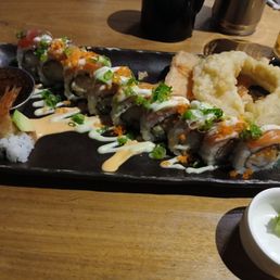 Cosmo Signature Roll. Salmon, Tuna, Tempura Shrimp, spicy mayo, avocado, honey wasabi aioli, wasabi tobiko. Cosmo Signature Roll. Salmon, Tuna, Tempura Shrimp, spicy mayo, avocado, honey wasabi aioli, wasabi tobiko.